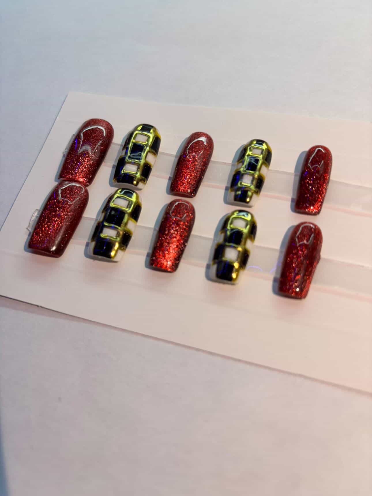 Red cat eyed and checkered press on nails.
