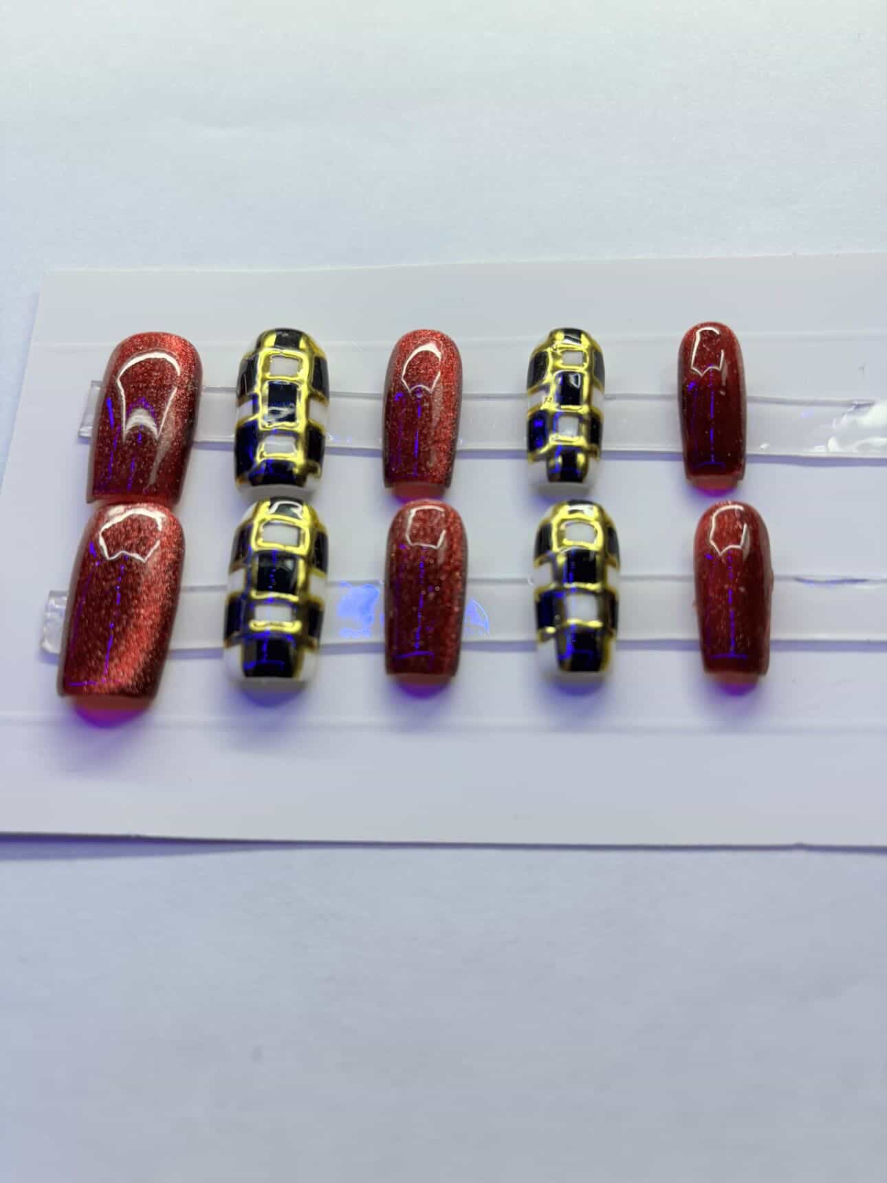 Red cat eyed and checkered press on nails.